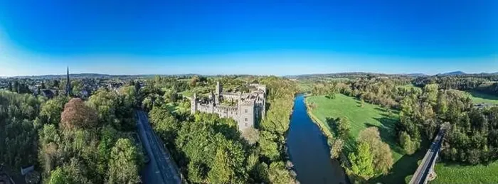 Framed Print : An aerial panorama reveals the majestic Lismore Castle in County Waterford, Ireland, set against a flawless spring sky