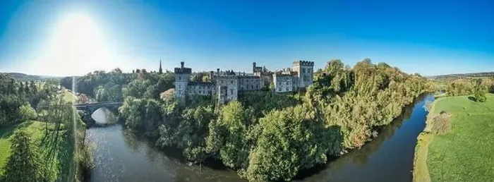 Framed Print : An aerial panorama reveals the majestic Lismore Castle in County Waterford, Ireland, set against a flawless spring sky Framed Print : An aerial panorama reveals the majestic Lismore Castle in County Waterford, Ireland, set against a flawless spring sky