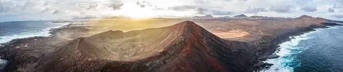 Framed Print : aerial panorama view on volcano and mountains on coast with ocean waves on lanzarote during sunrise Framed Print : aerial panorama view on volcano and mountains on coast with ocean waves on lanzarote during sunrise