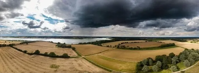 Framed Print : Aerial panoramic of the British countryside with a thunderstorm rolling in Framed Print : Aerial panoramic of the British countryside with a thunderstorm rolling in