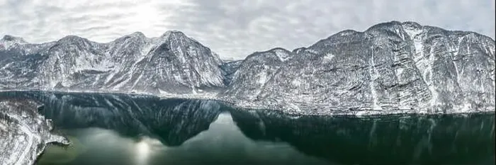 Framed Print : Aerial panoramic drone shot of Hallstatt village by lake surrounded by snow covered mountain in overcast winter time in Framed Print : Aerial panoramic drone shot of Hallstatt village by lake surrounded by snow covered mountain in overcast winter time in
