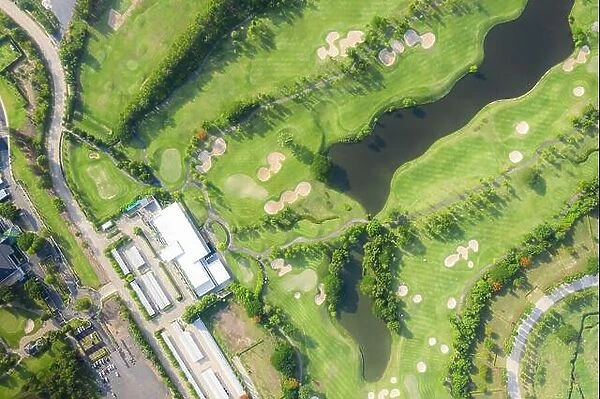 Aerial panoramic view of golf course and houses in city