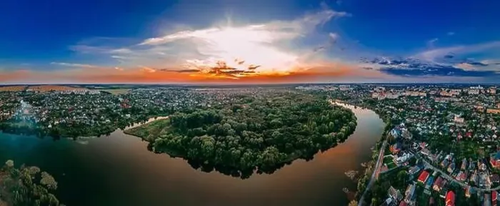 Framed Print : Aerial panoramic view of of small european city placed on river banks at summer sunny day with clouds Framed Print : Aerial panoramic view of of small european city placed on river banks at summer sunny day with clouds
