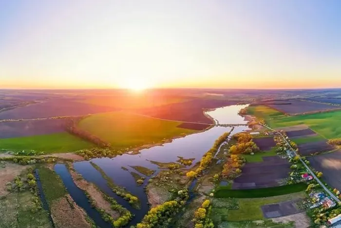 Framed Print : Aerial photo of sunset countryside landscape with lake, green fields and village Framed Print : Aerial photo of sunset countryside landscape with lake, green fields and village
