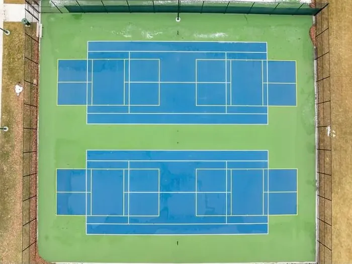 Framed Print : Aerial photo of unusually painted outdoor blue tennis courts with yellow pickleball lines and green out of bounds area Framed Print : Aerial photo of unusually painted outdoor blue tennis courts with yellow pickleball lines and green out of bounds area