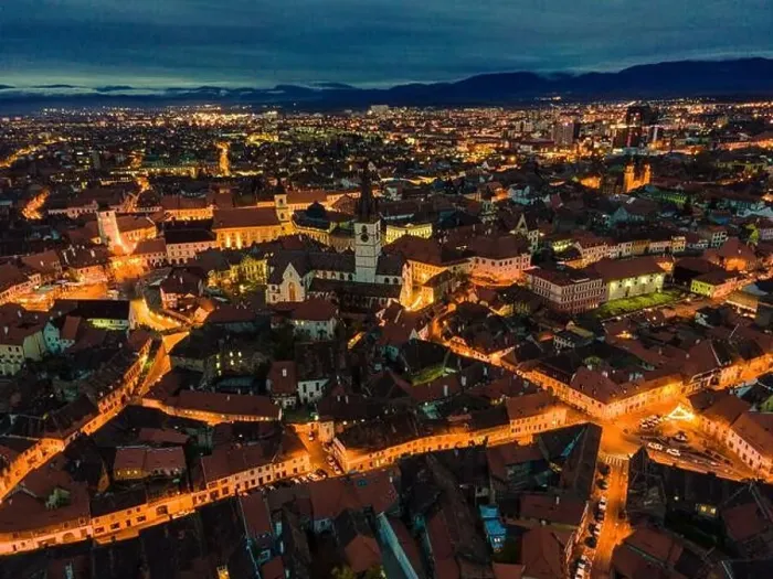 Framed Print : Aerial photography of Sibiu city center shot from a drone at sunset with city lights on. View from above Sibiu, Romania Framed Print : Aerial photography of Sibiu city center shot from a drone at sunset with city lights on. View from above Sibiu, Romania