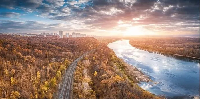 Framed Print : Aerial scenic panorama of railroad at city suburbs. Majestic sunset clouds reflecting in the river waters Framed Print : Aerial scenic panorama of railroad at city suburbs. Majestic sunset clouds reflecting in the river waters