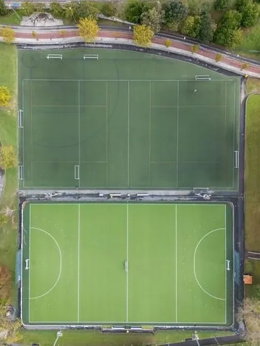 Framed Print : An aerial shot captures two adjacent, empty sports fields with clear markings, surrounded by greenery Framed Print : An aerial shot captures two adjacent, empty sports fields with clear markings, surrounded by greenery