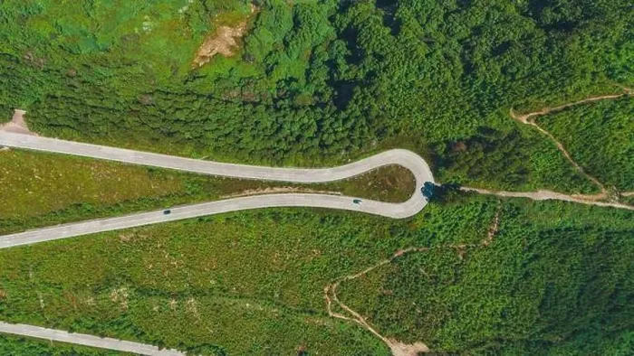Framed Print : Aerial shot captures the verdant landscape of Azores with winding roads curving through lush greenery Framed Print : Aerial shot captures the verdant landscape of Azores with winding roads curving through lush greenery