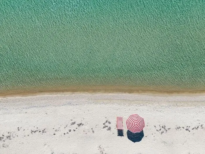 Framed Print : Aerial shot of an empty sandy beach and sea with a sun lounger and umbrella Framed Print : Aerial shot of an empty sandy beach and sea with a sun lounger and umbrella