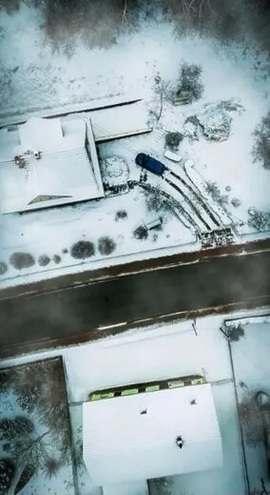 Framed Print : Aerial shot of a street covered with snow next to two A shaped house and a car Framed Print : Aerial shot of a street covered with snow next to two A shaped house and a car