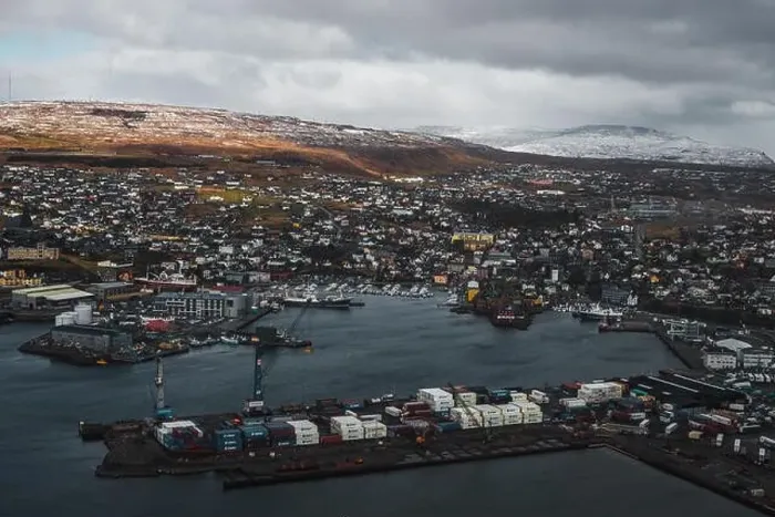 Framed Print : Aerial shot of the town Torshavn and its harbour as taken during a helicopter flight on an early spring morning Framed Print : Aerial shot of the town Torshavn and its harbour as taken during a helicopter flight on an early spring morning