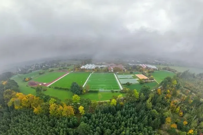 Framed Print : Aerial of a soccer pitch in the fall season with a lot of fog and a forest in the foreground Framed Print : Aerial of a soccer pitch in the fall season with a lot of fog and a forest in the foreground