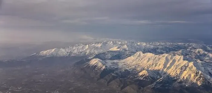 Framed Print : Aerial view from airplane of the Wasatch Front Rocky Mountain Range with snow capped peaks in winter including urban