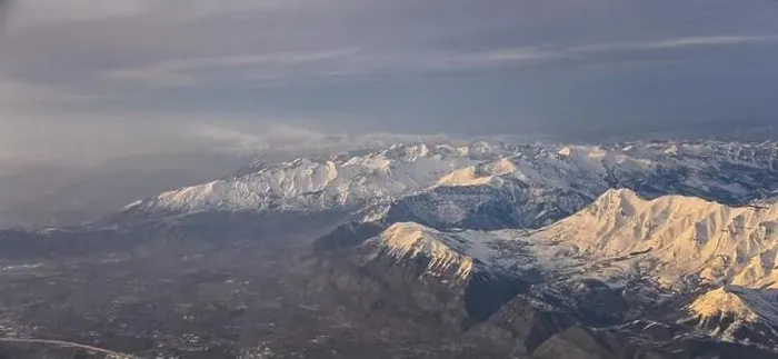 Framed Print : Aerial view from airplane of the Wasatch Front Rocky Mountain Range with snow capped peaks in winter including urban