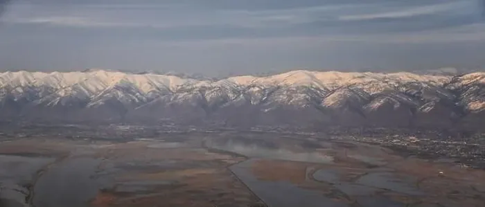Framed Print : Aerial view from airplane of the Wasatch Front Rocky Mountain Range with snow capped peaks in winter including urban Framed Print : Aerial view from airplane of the Wasatch Front Rocky Mountain Range with snow capped peaks in winter including urban
