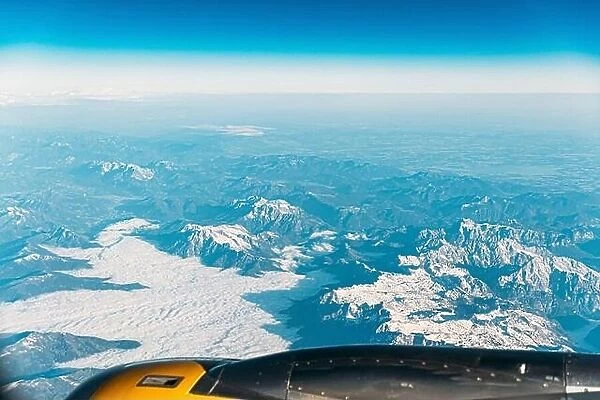 Aerial View From Airplane Window On Snowy Top Of Tatra Mountains In Summer Day. High Attitude