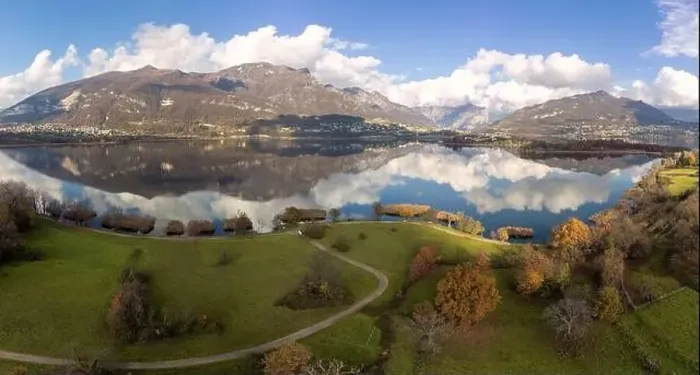 Framed Print : Aerial view of an alpine lake and the surrounding mountains and vegetations reflected on a cloudy day Framed Print : Aerial view of an alpine lake and the surrounding mountains and vegetations reflected on a cloudy day