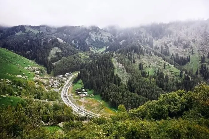 Framed Print : Aerial view of the alpine village and river in the mountains at foggy clouds. Photo taken with Drone Framed Print : Aerial view of the alpine village and river in the mountains at foggy clouds. Photo taken with Drone