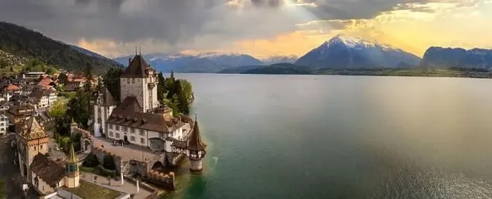 Framed Print : Aerial view of amazing romantic castle Oberhofen over sunset light. scenic Thun lake, Switzerland travel and landmarks Framed Print : Aerial view of amazing romantic castle Oberhofen over sunset light. scenic Thun lake, Switzerland travel and landmarks