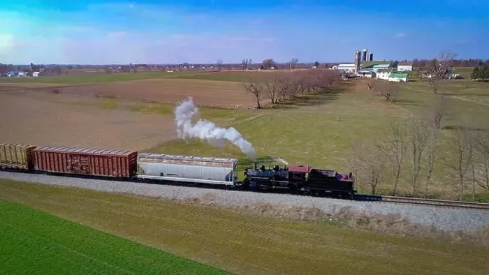 Framed Print : Aerial View of an Antique Steam Engine Doing Switching Dues at a Freight Yard in the Middle of Farmlands on a Sunny Day Framed Print : Aerial View of an Antique Steam Engine Doing Switching Dues at a Freight Yard in the Middle of Farmlands on a Sunny Day