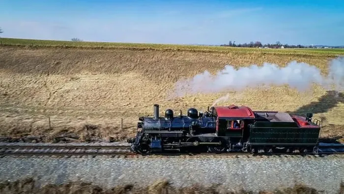 Framed Print : Aerial View of an Antique Steam Engine Traveling by Itself in the Middle of Farmlands on Sunny Day Framed Print : Aerial View of an Antique Steam Engine Traveling by Itself in the Middle of Farmlands on Sunny Day