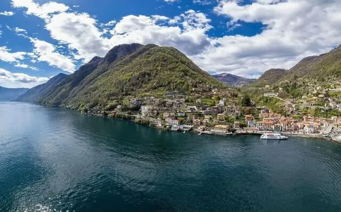 Framed Print : Aerial view of Argegno, idyllic village on Lake Como, Lombardy, Italy. Ferry boat loading passengers waiting to leave Framed Print : Aerial view of Argegno, idyllic village on Lake Como, Lombardy, Italy. Ferry boat loading passengers waiting to leave