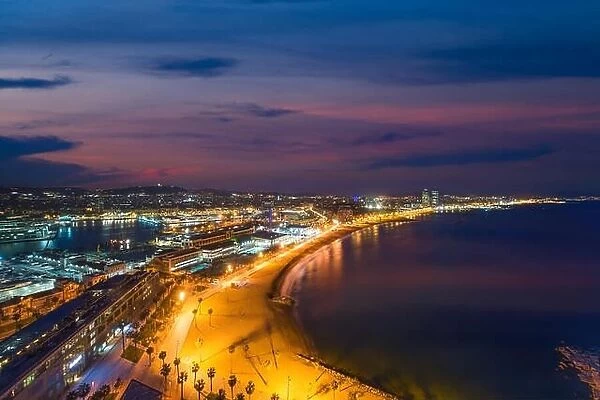 Aerial view of Barcelona Beach in summer night along seaside in Barcelona, Spain. Mediterranean Sea in Spain