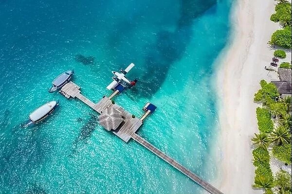 Aerial view of beach in Maldives. Amazing aerial landscape in Maldives islands, blue sea and coral reef view from drone or plane. Exotic summer travel