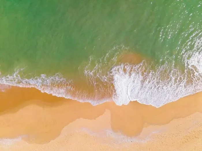 Framed Print : Aerial view of a beach and waves along the sea Framed Print : Aerial view of a beach and waves along the sea