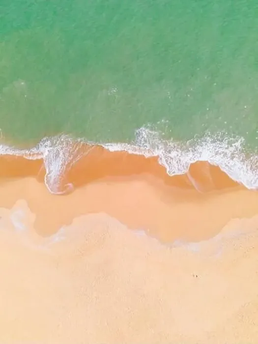 Framed Print : Aerial view of a beach and waves along the sea Framed Print : Aerial view of a beach and waves along the sea