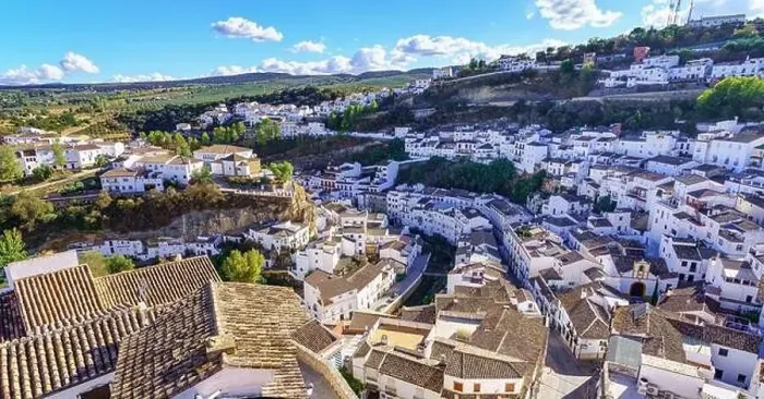 Framed Print : Aerial view of a beautiful Andalusian village of white houses built on the mountainside, Setenil de las Bodegas, Cadiz Framed Print : Aerial view of a beautiful Andalusian village of white houses built on the mountainside, Setenil de las Bodegas, Cadiz