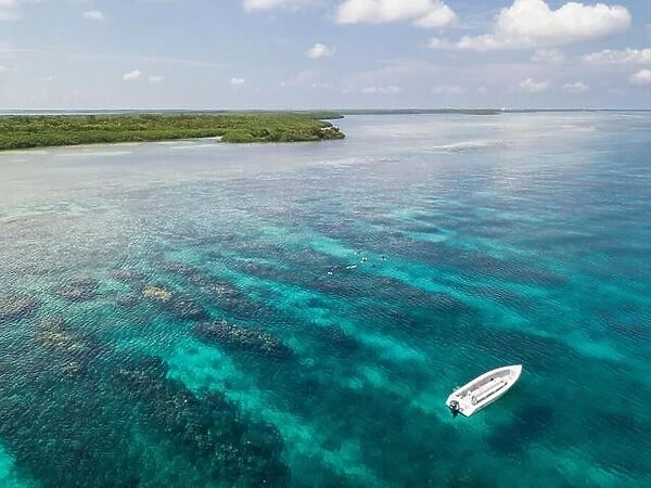 An aerial view of a beautiful coral reef on the edge of Turneffe Atoll off the coast of Belize. This area of the Caribbean is extremely biodiverse