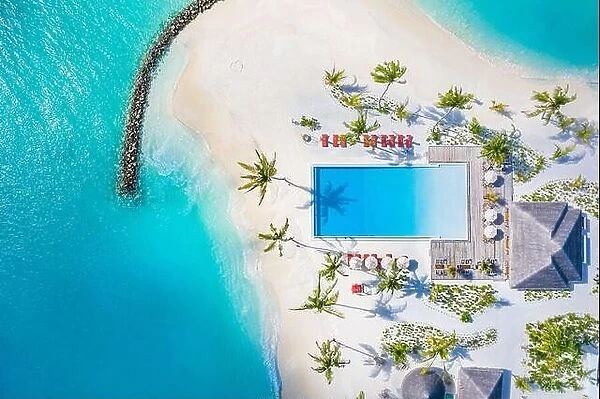 Aerial view of beautiful hotel summer landscape sea shore, coast, azure sea water, sandy beach, palm trees infinity pool, chairs, beds. Luxury resort