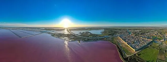 Framed Print : Aerial view of the beautiful pink lake and salt production of the Camargue in front of the village of Aigues Mortes Framed Print : Aerial view of the beautiful pink lake and salt production of the Camargue in front of the village of Aigues Mortes