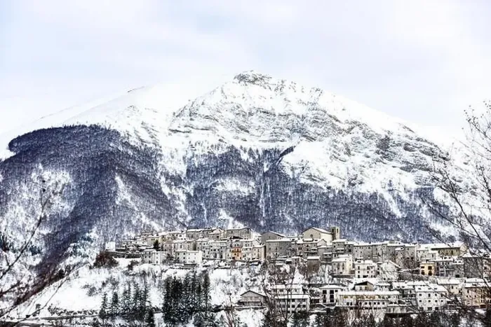 Framed Print : Aerial view of the beautiful snow-covered village of Opi with snow-capped mountains in the background Framed Print : Aerial view of the beautiful snow-covered village of Opi with snow-capped mountains in the background
