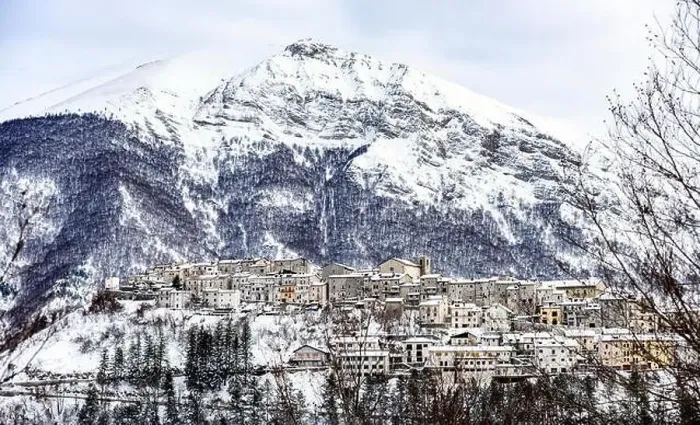 Framed Print : Aerial view of the beautiful snow-covered village of Opi with snow-capped mountains in the background Framed Print : Aerial view of the beautiful snow-covered village of Opi with snow-capped mountains in the background