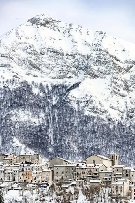 Framed Print : Aerial view of the beautiful snow-covered village of Opi with snow-capped mountains in the background Framed Print : Aerial view of the beautiful snow-covered village of Opi with snow-capped mountains in the background