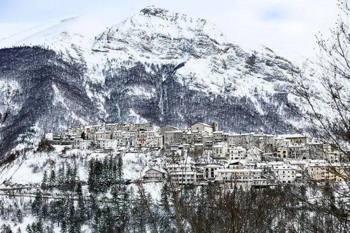 Framed Print : Aerial view of the beautiful snow-covered village of Opi with snow-capped mountains in the background Framed Print : Aerial view of the beautiful snow-covered village of Opi with snow-capped mountains in the background