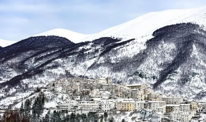 Framed Print : Aerial view of the beautiful snow-covered village of Opi with snow-capped mountains in the background Framed Print : Aerial view of the beautiful snow-covered village of Opi with snow-capped mountains in the background