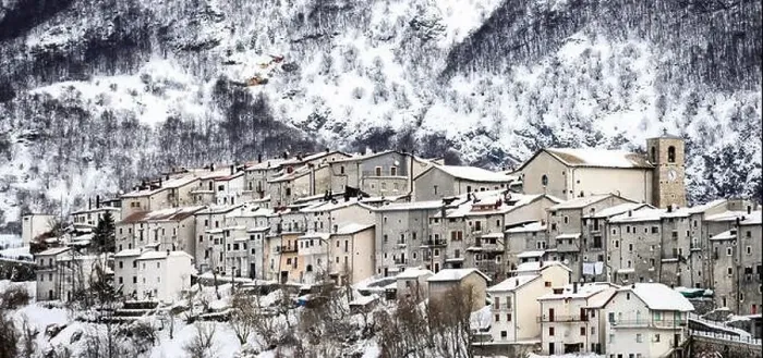 Framed Print : Aerial view of the beautiful snow-covered village of Opi with snow-capped mountains in the background Framed Print : Aerial view of the beautiful snow-covered village of Opi with snow-capped mountains in the background
