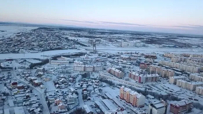 Framed Print : Aerial view of a big city with building roofs covered by snow. Clip. Flying above frozen city and a river Framed Print : Aerial view of a big city with building roofs covered by snow. Clip. Flying above frozen city and a river