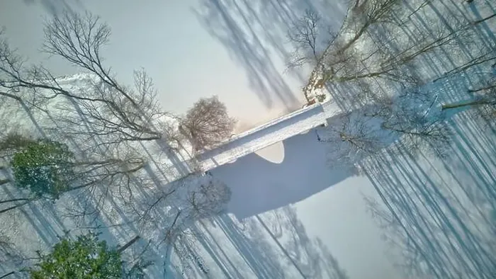 Framed Print : Aerial view of the bridge in the park, frozen pond, long shadow of trees, beautiful winter scenery Framed Print : Aerial view of the bridge in the park, frozen pond, long shadow of trees, beautiful winter scenery