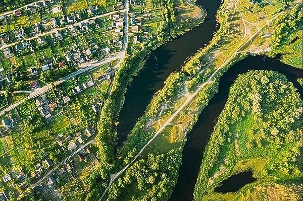 Aerial View Of Calm River And Village In Belarus, Europe. Green Forest Woods Landscape In Sunny Summer Evening. Top View Of Beautiful European Nature