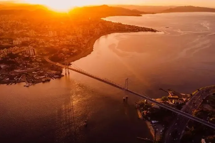 Framed Print : Aerial view of city and Hercilio luz bridge with bright sunset in Florianopolis, Brazil Framed Print : Aerial view of city and Hercilio luz bridge with bright sunset in Florianopolis, Brazil