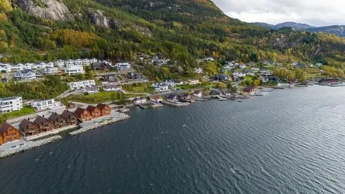 Framed Print : Aerial view of a coastal village with wooden houses along a fjord, surrounded by forested hills in autumn colors Framed Print : Aerial view of a coastal village with wooden houses along a fjord, surrounded by forested hills in autumn colors