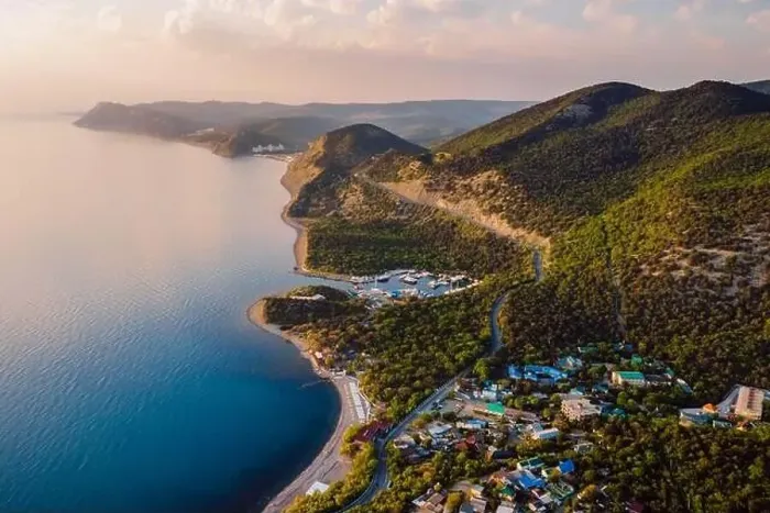 Framed Print : Aerial view of coastline with blue sea, mountains with trees, cliffs with sunset light Framed Print : Aerial view of coastline with blue sea, mountains with trees, cliffs with sunset light