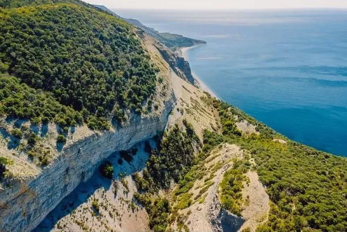 Framed Print : Aerial view of coastline with blue sea, mountains, canyon and cliffs with daylight