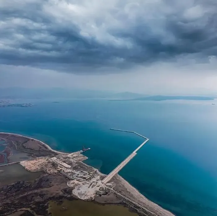 Framed Print : Aerial view of a Construction of a marina from a drone with blue sea water and clouds on sky Framed Print : Aerial view of a Construction of a marina from a drone with blue sea water and clouds on sky