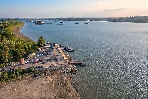 Aerial view of Danube ferry near Galati City, Romania. Danube River near city with sunset warm light